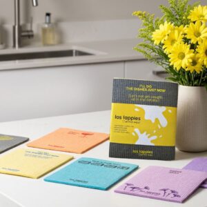 OG los lappies set of 4 reusable cellulose cloths in yellow, charcoal and cream prints on a kitchen counter.